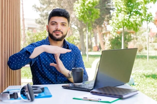 brunette-asian-boy-with-beard-sitting-working-showing-stop_651396-3024